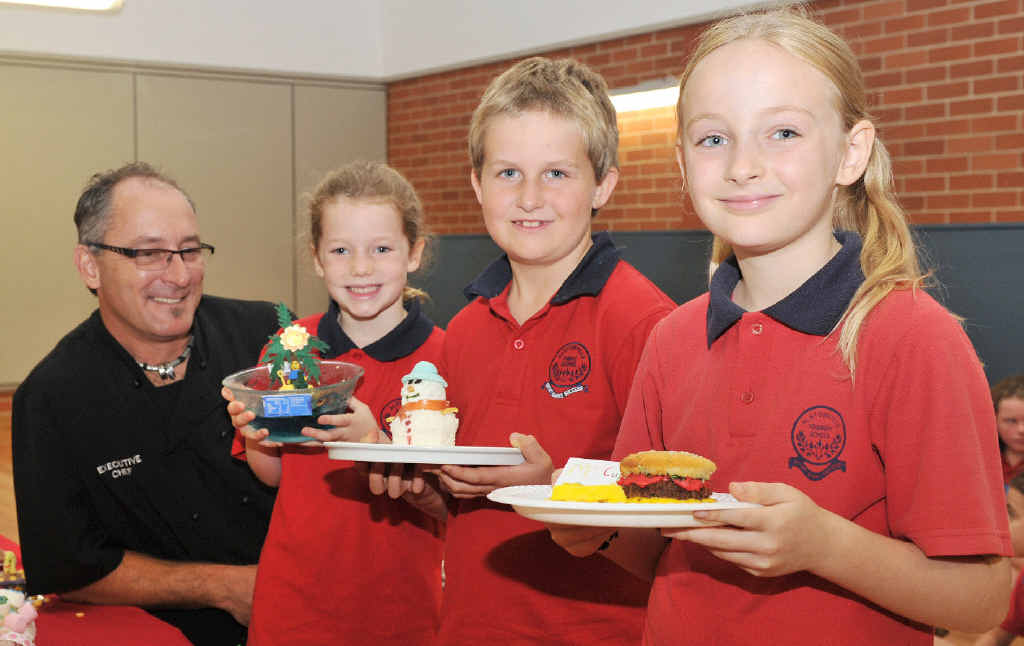 CUPCAKE GURUS: Ballina RSL executive chef Gerhard Spatz, Zoe Ball (3rd place: Tropical Island), Joe Gardner (2nd place: Snowman) and Tully Veronesi (1st place: hamburger and Fries) at Alstonville Public School. INSET: The winning cupcake, made by Tully Veronesi. CUPCAKE GURUS: Ballina RSL executive chef Gerhard Spatz, Zoe Ball (3rd place: Tropical Island), Joe Gardner (2nd place: Snowman) and Tully Veronesi (1st place: hamburger and Fries) at Alstonville Public School. INSET: The winning cupcake, made by Tully Veronesi.
