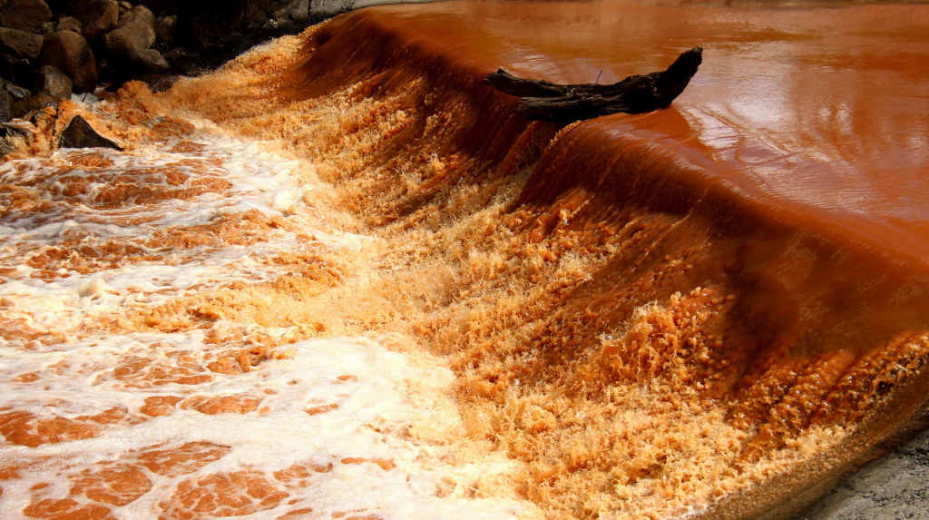 The Condamine River was flowing a dark brown/red colour yesterday.