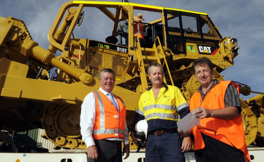 Looking over the bulldozers in Toowoomba before they make their way to Western Australia are (from left) Mark Pettiford, Davyn Simpson and Alan Johnson. Looking over the bulldozers in Toowoomba before they make their way to Western Australia are (from left) Mark Pettiford, Davyn Simpson and Alan Johnson.