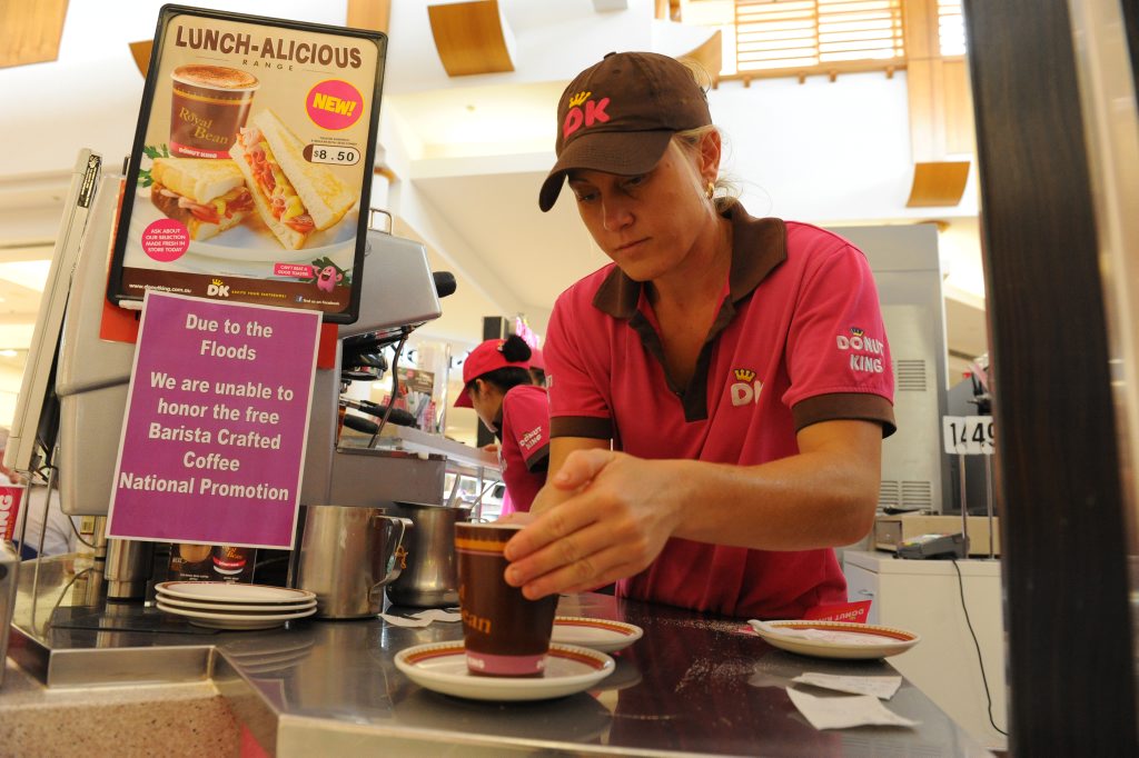 ROYAL BEAN: Donut King manager Jessica Denniss was extremely busy preparing coffee for her customers in the Sugarland Shopping Town mall. Photo: Mike Knott / NewsMail ROYAL BEAN: Donut King manager Jessica Denniss was extremely busy preparing coffee for her customers in the Sugarland Shopping Town mall. Photo: Mike Knott / NewsMail