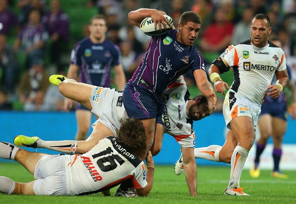 Kenny Bromwich of the Storm is tackled by Matt Bell and Aaron Woods of the Tigers during the round 5 NRL match between the Melbourne Storm and the Wests Tigers at AAMI Stadium on April 8, 2013 in Adelaide, Australia. Kenny Bromwich of the Storm is tackled by Matt Bell and Aaron Woods of the Tigers during the round 5 NRL match between the Melbourne Storm and the Wests Tigers at AAMI Stadium on April 8, 2013 in Adelaide, Australia.