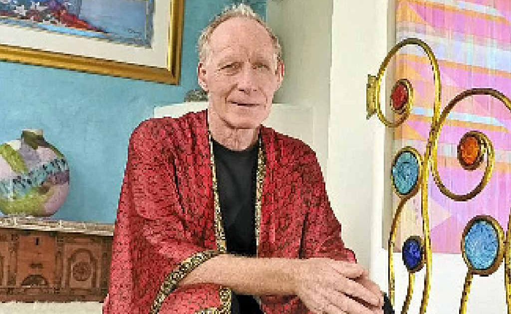 ABOVE: Colin Heaney seated on the staircase in his house. Note the balustrade details of glass and metal. Colin designed this and a friend made up the metal pieces, then Colin added the glass detail. This quirky colourful design is typical of Colin’s style and talent. ABOVE: Colin Heaney seated on the staircase in his house. Note the balustrade details of glass and metal. Colin designed this and a friend made up the metal pieces, then Colin added the glass detail. This quirky colourful design is typical of Colin’s style and talent.