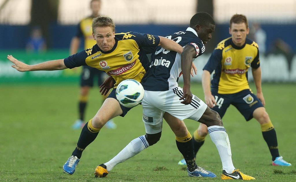 Daniel McBreen of the Mariners competes for the ball with Jason Geria of the Victory during the A-League Semi Final match between the Central Coast Mariners and the Melbourne Victory at Bluetongue Stadium on April 14, 2013 in Gosford, Australia. Daniel McBreen of the Mariners competes for the ball with Jason Geria of the Victory during the A-League Semi Final match between the Central Coast Mariners and the Melbourne Victory at Bluetongue Stadium on April 14, 2013 in Gosford, Australia.