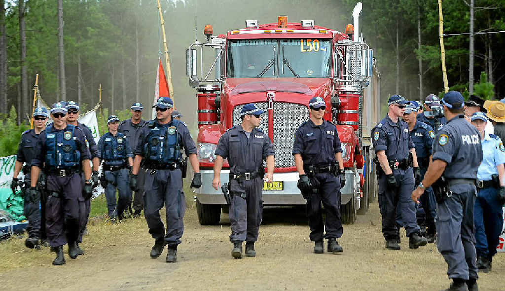 SAFE PASSAGE: Police escort a truck from The Doubtful Creek CSG mining site in February. SAFE PASSAGE: Police escort a truck from The Doubtful Creek CSG mining site in February.