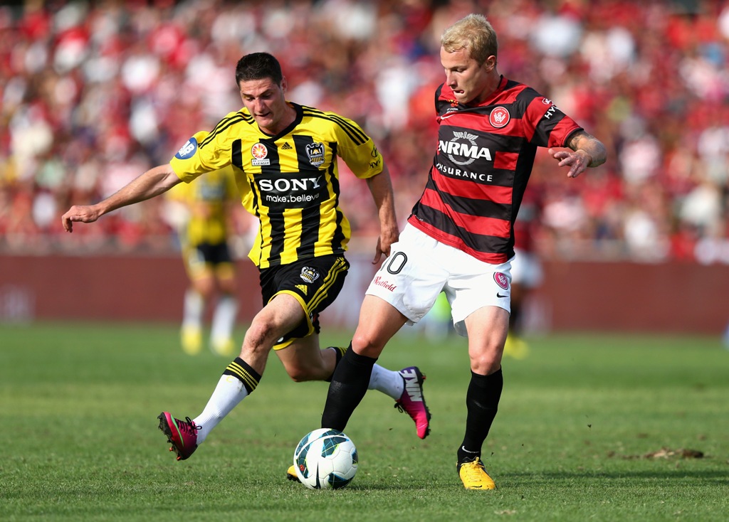 Aaron Mooy of the Wanderers competes for the ball against Corey Gameiro of the Phoenix during the round 24 A-League match between the Western Sydney Wanderers and the Wellington Phoenix at Parramatta Stadium on March 10, 2013 in Sydney, Australia. Aaron Mooy of the Wanderers competes for the ball against Corey Gameiro of the Phoenix during the round 24 A-League match between the Western Sydney Wanderers and the Wellington Phoenix at Parramatta Stadium on March 10, 2013 in Sydney, Australia.