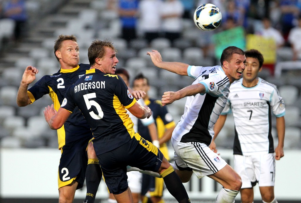 Eddy Bosnar of Suwon heads the ball against Daniel McBreen and Zac Anderson of the Mariners during the AFC Asian Champions League match between the Central Coast Mariners and Suwon. Eddy Bosnar of Suwon heads the ball against Daniel McBreen and Zac Anderson of the Mariners during the AFC Asian Champions League match between the Central Coast Mariners and Suwon.