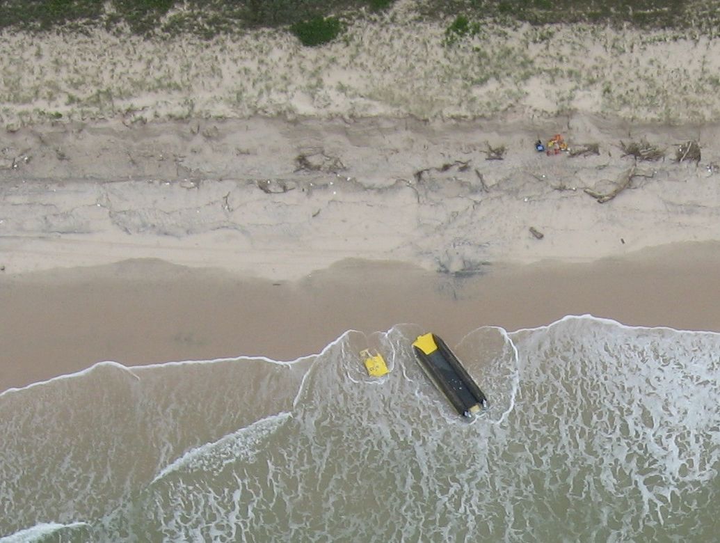 An aerial photograph of the Ballina Marine Rescue boat washed up at South Ballina after flipping during a rescue. The photo was taken by former Ballina councillor and pilot Margaret Howes. An aerial photograph of the Ballina Marine Rescue boat washed up at South Ballina after flipping during a rescue. The photo was taken by former Ballina councillor and pilot Margaret Howes.