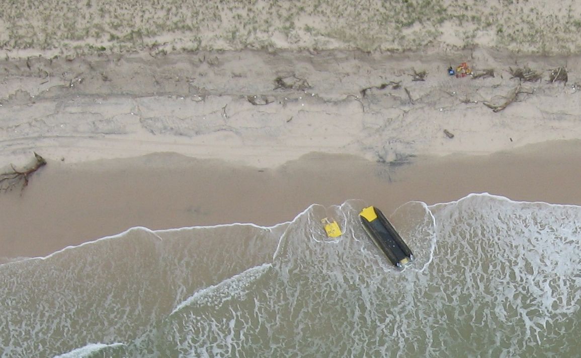 An aerial photograph of the Ballina Marine Rescue boat washed up at South Ballina after flipping during a rescue. The photo was taken by former Ballina councillor and pilot Margaret Howes. An aerial photograph of the Ballina Marine Rescue boat washed up at South Ballina after flipping during a rescue. The photo was taken by former Ballina councillor and pilot Margaret Howes.
