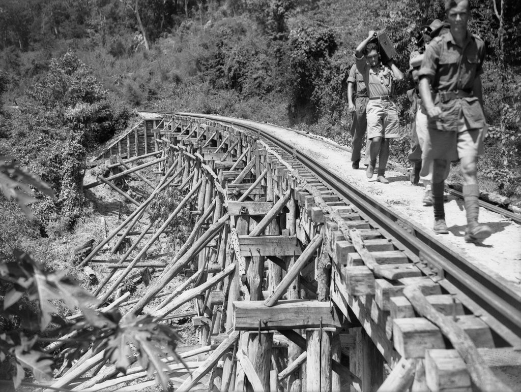 Members of the Military History Section Field Team crossing a trestle bridge near Kinsaiyok, Thailand, Photo Department of Veteran Affairs Members of the Military History Section Field Team crossing a trestle bridge near Kinsaiyok, Thailand, Photo Department of Veteran Affairs