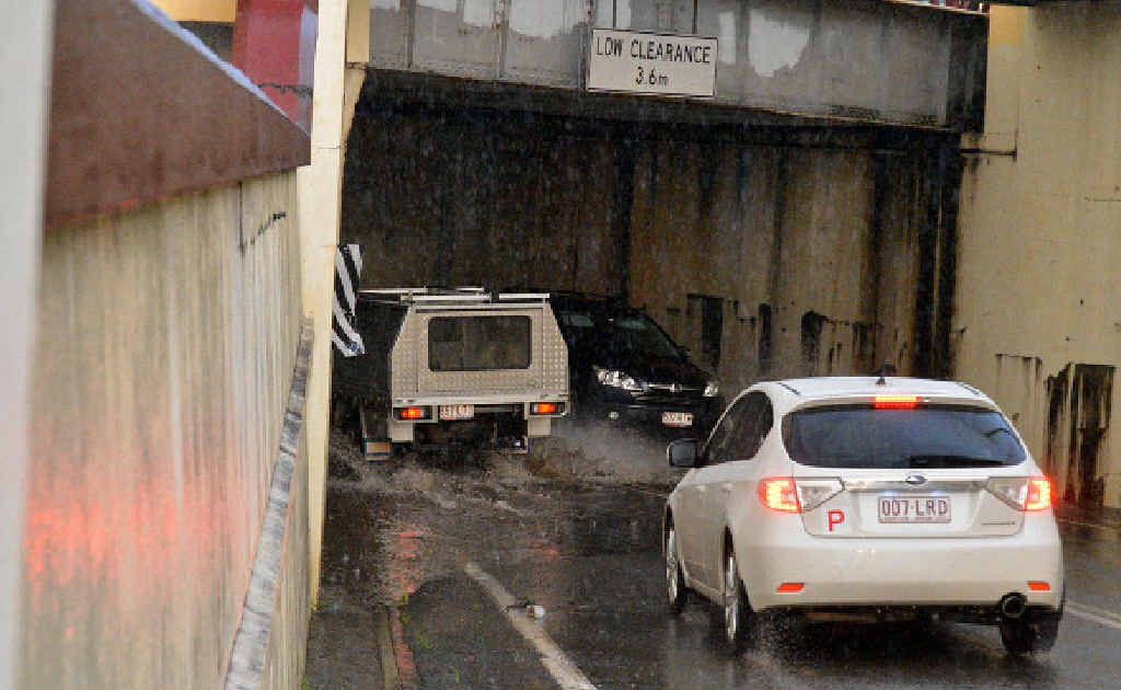 Drivers navigate flash flooding at the Gympie Railway Station subway yesterday afternoon. Drivers navigate flash flooding at the Gympie Railway Station subway yesterday afternoon.
