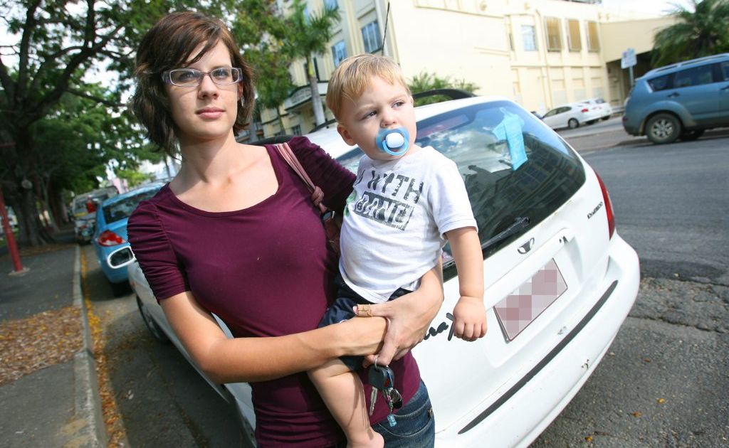 Crystal Ferris with her 16 month old son Reuben alongside her car which was damaged when a truck ran into it. Photo: Chris Ison / The Morning Bulletin Crystal Ferris with her 16 month old son Reuben alongside her car which was damaged when a truck ran into it. Photo: Chris Ison / The Morning Bulletin