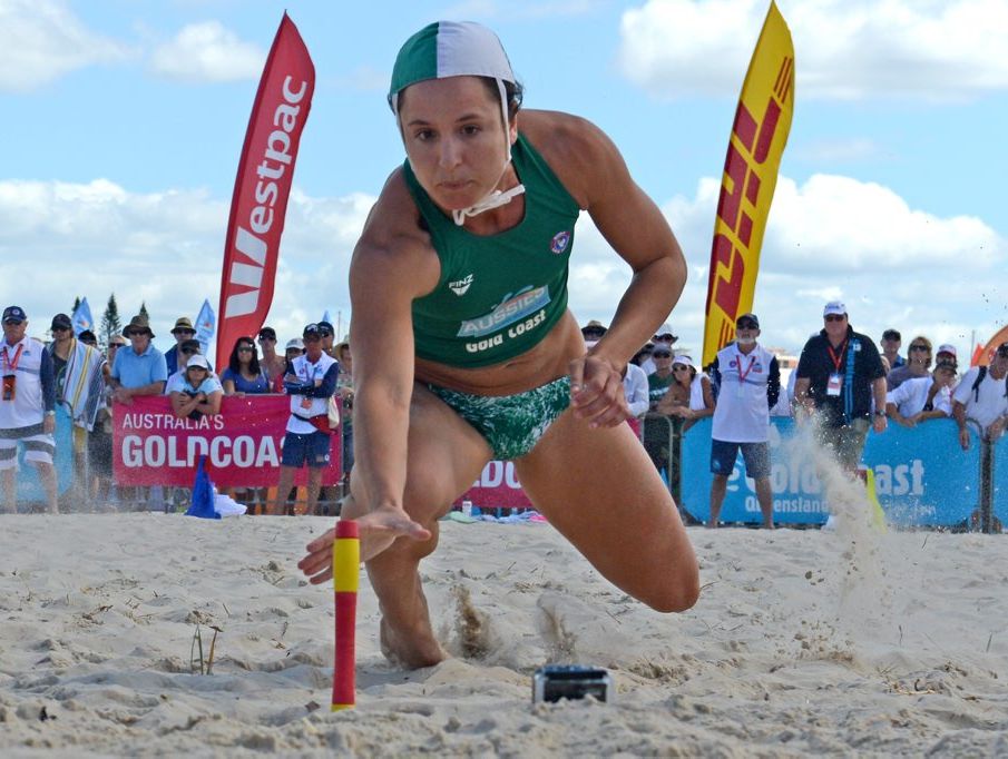 A Currumbin competitor reaches out for a place in the next round. Photo: Blainey Woodham / Daily News