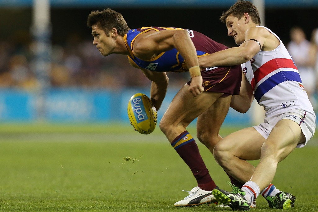 Simon Black of the Lions is tackled by Clay Smith of the Bulldogs during the round 23 AFL match between the Brisbane Lions and the Western Bulldogs at The Gabba on September 2, 2012 in Brisbane, Australia. Simon Black of the Lions is tackled by Clay Smith of the Bulldogs during the round 23 AFL match between the Brisbane Lions and the Western Bulldogs at The Gabba on September 2, 2012 in Brisbane, Australia.