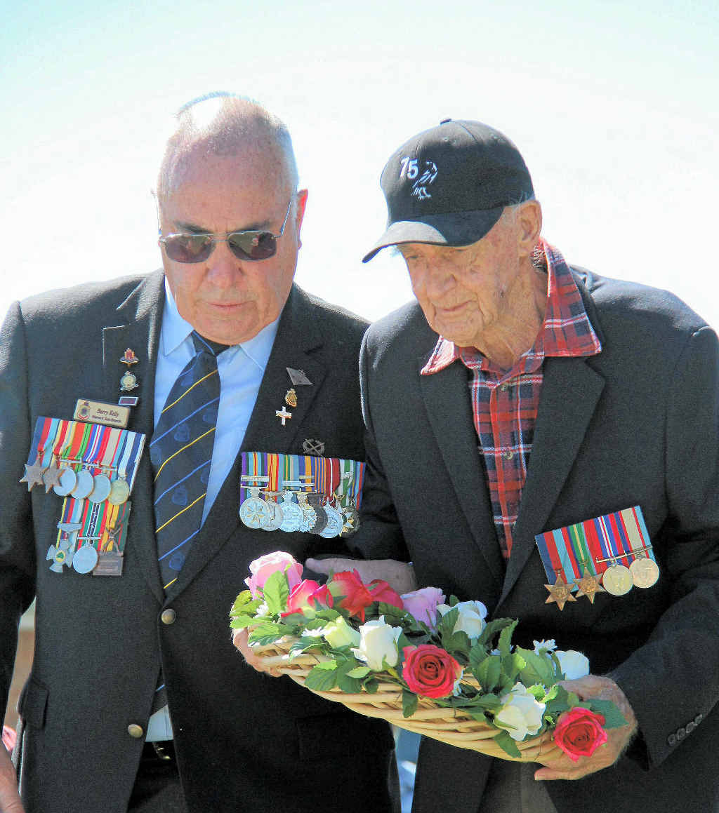 Warwick RSL sub-branch chaplain Barry Kelly helped veteran Edgar McCulloch lay a wreath at the flag pole during the Akooramak Anzac Day.