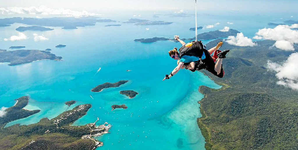 Two skydivers plunge in tandem after jumping out over the spectacular Whitsunday area. Two skydivers plunge in tandem after jumping out over the spectacular Whitsunday area.
