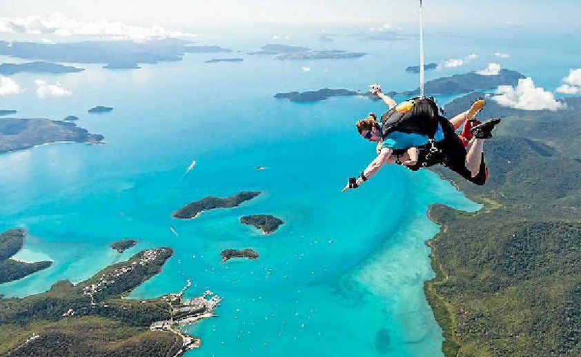 Two skydivers plunge in tandem after jumping out over the spectacular Whitsunday area. Two skydivers plunge in tandem after jumping out over the spectacular Whitsunday area.