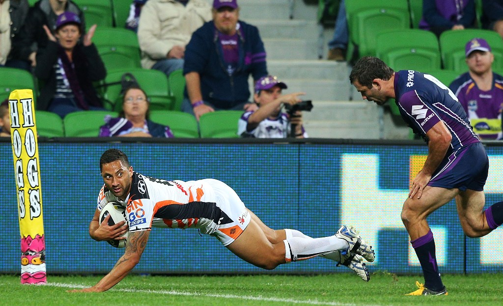 Benji Marshall of the Tigers scores a try past Cameron Smith of the Storm during the round 5 NRL match between the Melbourne Storm and the Wests Tigers at AAMI Stadium on April 8, 2013 in Melbourne, Australia. Benji Marshall of the Tigers scores a try past Cameron Smith of the Storm during the round 5 NRL match between the Melbourne Storm and the Wests Tigers at AAMI Stadium on April 8, 2013 in Melbourne, Australia.