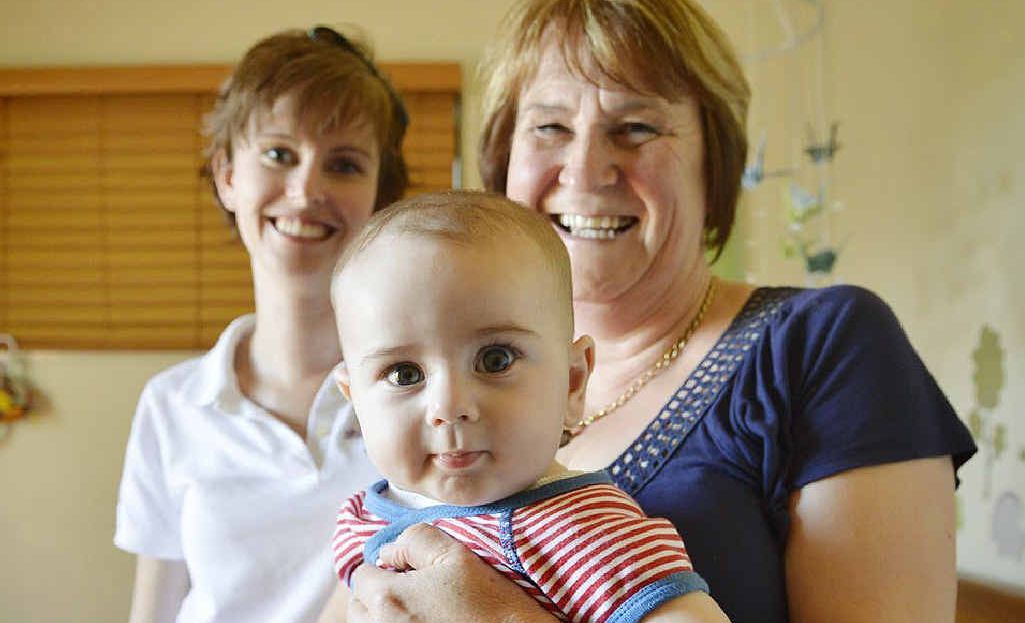 ALL SETTLED: Midwife Hazel Mastin holds Emma McLeod’s six-month-old son Connor. ALL SETTLED: Midwife Hazel Mastin holds Emma McLeod’s six-month-old son Connor.