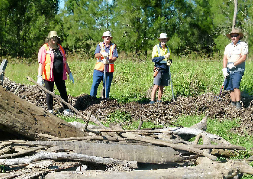 Sandy and Bevan Eyles from Western Australia, team leader Bob Zerbel from Brisbane (but who has not been home for three years) and Murgon farmer James Mitchell take a break from removing flood debris that has piled against the fence. Sandy and Bevan Eyles from Western Australia, team leader Bob Zerbel from Brisbane (but who has not been home for three years) and Murgon farmer James Mitchell take a break from removing flood debris that has piled against the fence.