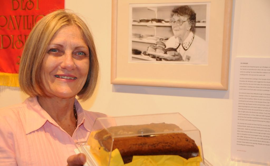 Noela Lewis, daughter of Iris Wolski, known for her cooking and exhibits at many Gympie shows, came from Brisbane to see the exhibition. Noela holds on to a cake baked for the evening’s celebration using her mother’s recipe. Noela Lewis, daughter of Iris Wolski, known for her cooking and exhibits at many Gympie shows, came from Brisbane to see the exhibition. Noela holds on to a cake baked for the evening’s celebration using her mother’s recipe.
