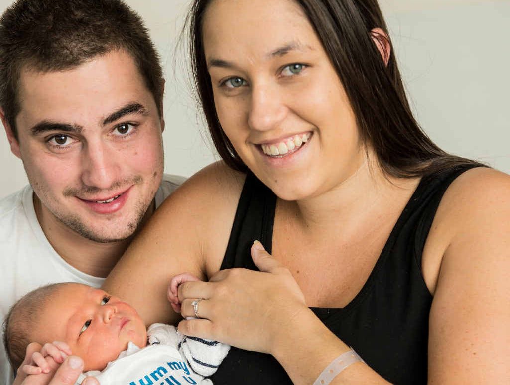NEW PARENTS: Jaimie Abell and Angie Gwynne with little baby Nixon and his keepsake singlet. NEW PARENTS: Jaimie Abell and Angie Gwynne with little baby Nixon and his keepsake singlet.