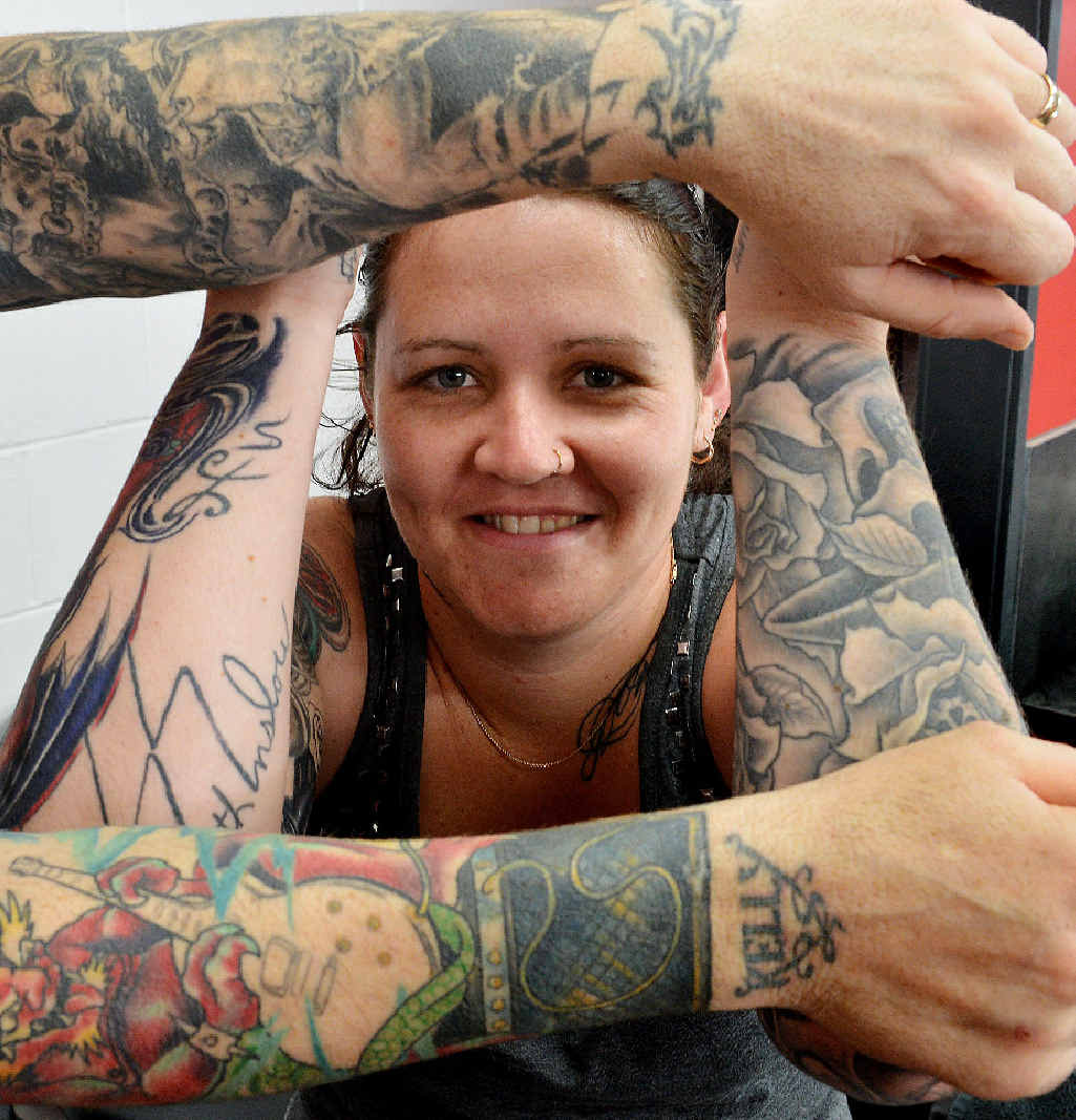 Mel Poole shows off her tattoos, alongside those of Maiden Ink Tattoos artist Mick Aplin.