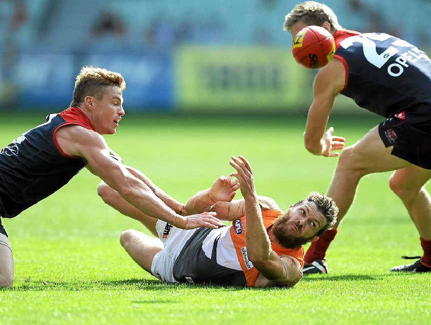 Sam Reid gets the ball away despite the best efforts of Melbourne’s Colin Sylvia and Tom McDonald at the MCG last month.