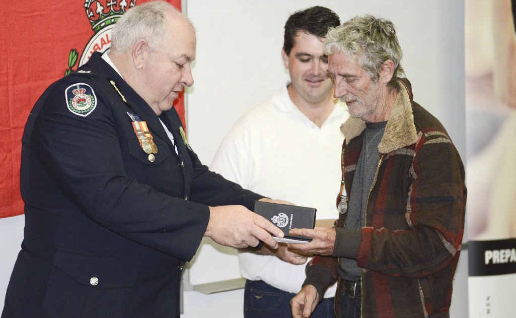 AWARDED: Bruce McDonald presents of Woombah with his long service medal. Photo Debrah Novak AWARDED: Bruce McDonald presents of Woombah with his long service medal. Photo Debrah Novak