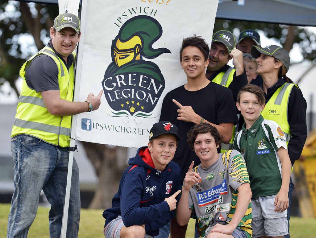 GO GREEN: Ipswich Sports House staff, including Kyron Williams, Brendan Bowers and Caitlin Boyd, join with supporters in promoting the Green Legion fans club at the Jets’ home ground on Sunday.