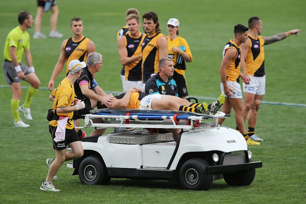 Tigers players looks on as team mate Chris Knights is taken from the field on a stretcher during the round seven AFL match between Port Adelaide Power and the Richmond Tigers at AAMI Stadium on May 11, 2013 in Adelaide, Australia. Tigers players looks on as team mate Chris Knights is taken from the field on a stretcher during the round seven AFL match between Port Adelaide Power and the Richmond Tigers at AAMI Stadium on May 11, 2013 in Adelaide, Australia.