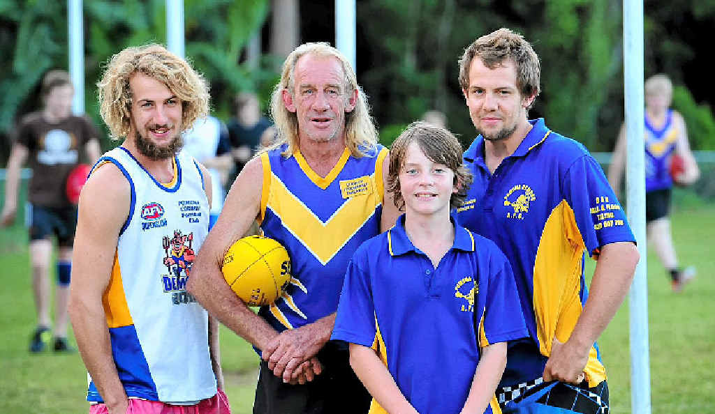Pomona Cooroy Football Club legend Billy Magin (with ball) plays his 700th game of Aussie rules on Sunday at the club’s Pomona ground. He is pictured with sons Lanze (left), Blake (right) and grandson Layton (front). Pomona Cooroy Football Club legend Billy Magin (with ball) plays his 700th game of Aussie rules on Sunday at the club’s Pomona ground. He is pictured with sons Lanze (left), Blake (right) and grandson Layton (front).