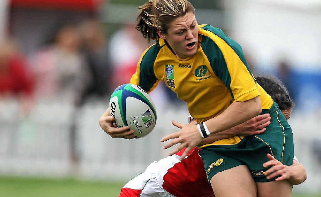 Australian captain Sharni Williams is tackled by Melissa Berry of Wales. Australian captain Sharni Williams is tackled by Melissa Berry of Wales.