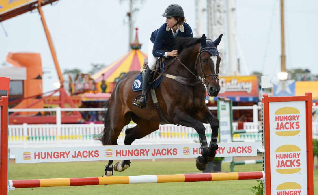 Kate Lewis goes over the Hungry Jacks jump at the Gympie Show. Kate Lewis goes over the Hungry Jacks jump at the Gympie Show.