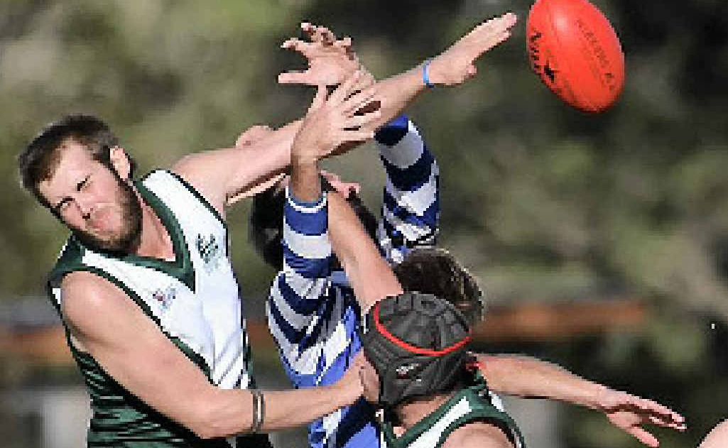 Gladstone’s Chris Zwar punches the ball clear against Brothers. Gladstone’s Chris Zwar punches the ball clear against Brothers.