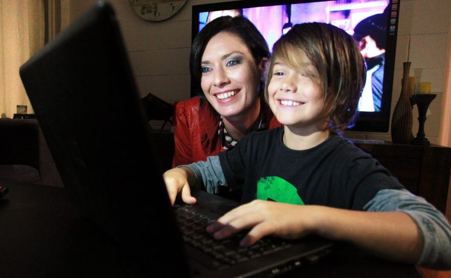 Jarrah Kearney, 8, navigates around the internet on the family laptop with mum, Reef, looking over his shoulder. Jarrah Kearney, 8, navigates around the internet on the family laptop with mum, Reef, looking over his shoulder.
