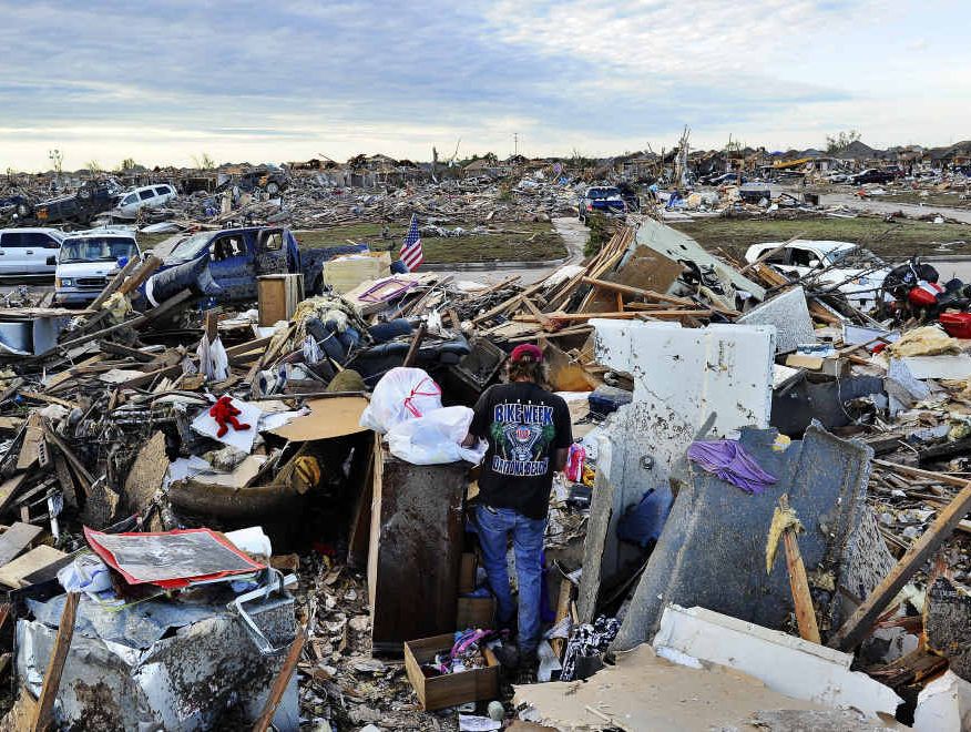 DESTROYED: People salvage items from their tornado-devastated homes on May 21 in Moore, Oklahoma. Families returned to a blasted moonscape that had been an American suburb after a tornado tore through the outskirts of Oklahoma City, killing at least 24 people.