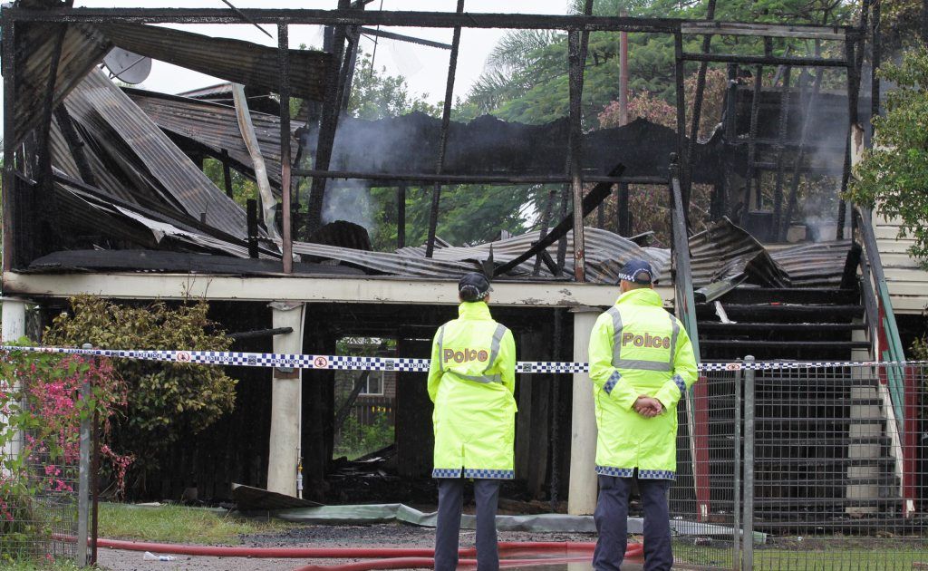 Police stand outside the gutted Churchill St house in February. Police stand outside the gutted Churchill St house in February.