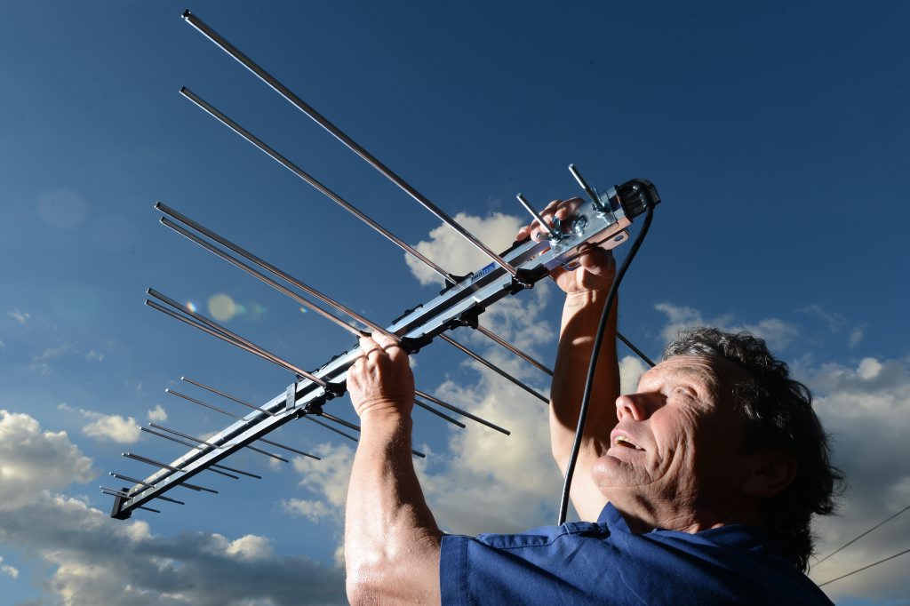 Image for sale: Gordon Jamieson installs intennas and is prepared for the digital switchover that is tomorrow. Photo: Sarah Harvey / The Queensland Times