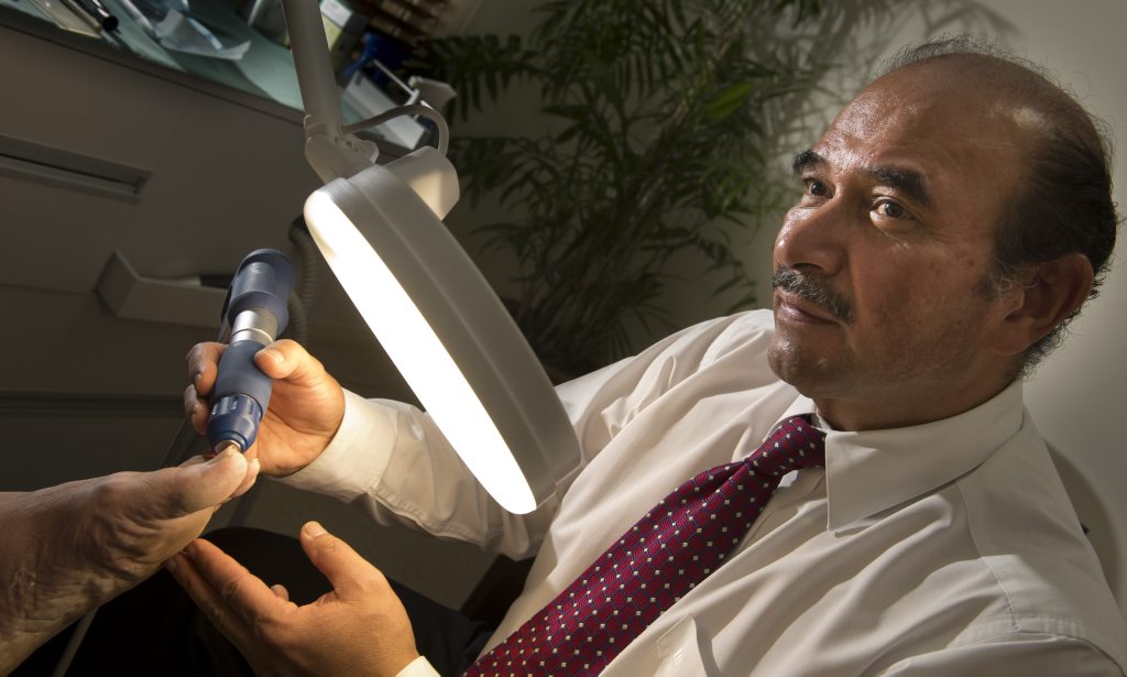 Nelson Gonzalez, James Street Footcare Centre uses the new fungus machine on a patient. Nelson Gonzalez, James Street Footcare Centre uses the new fungus machine on a patient.