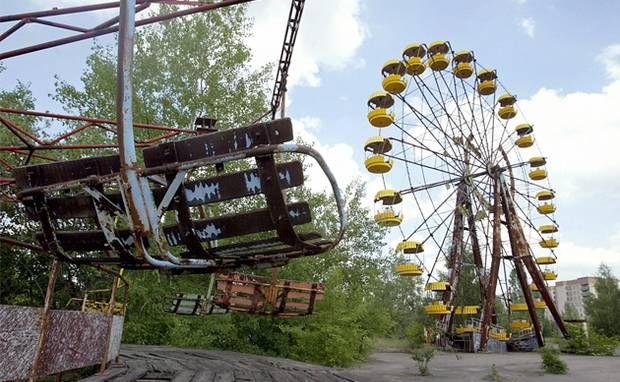 A ferris wheel and carousel abandoned in the amusement park in the ghost town of Prypyat, adjacent to the Chernobyl nuclear plant. A ferris wheel and carousel abandoned in the amusement park in the ghost town of Prypyat, adjacent to the Chernobyl nuclear plant.