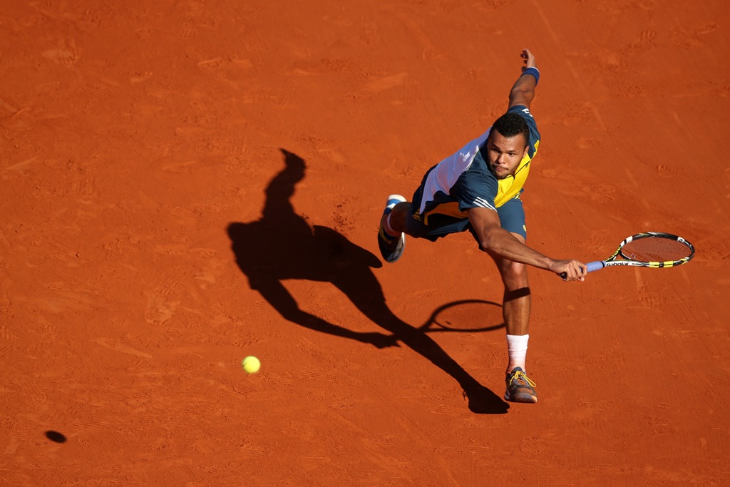 Jo-Wilfried Tsonga of France plays a backhand in his Men's Singles quarter final match against Roger Federer of Switzerland during day ten of the French Open at Roland Garros on June 4, 2013 in Paris, France. Jo-Wilfried Tsonga of France plays a backhand in his Men's Singles quarter final match against Roger Federer of Switzerland during day ten of the French Open at Roland Garros on June 4, 2013 in Paris, France.