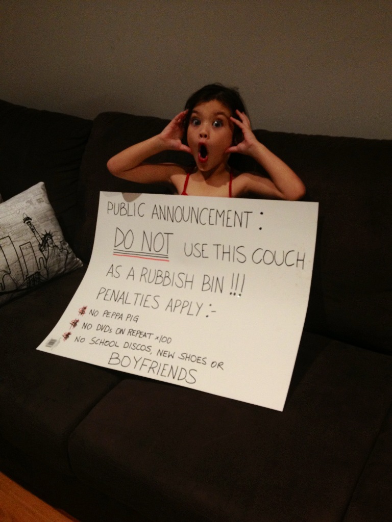 Six-year-old Indigo had an announcement board created by her mother to get the message across that if she dumps her rubbish in or behind the couch again, she faced harsh punishments. Six-year-old Indigo had an announcement board created by her mother to get the message across that if she dumps her rubbish in or behind the couch again, she faced harsh punishments.
