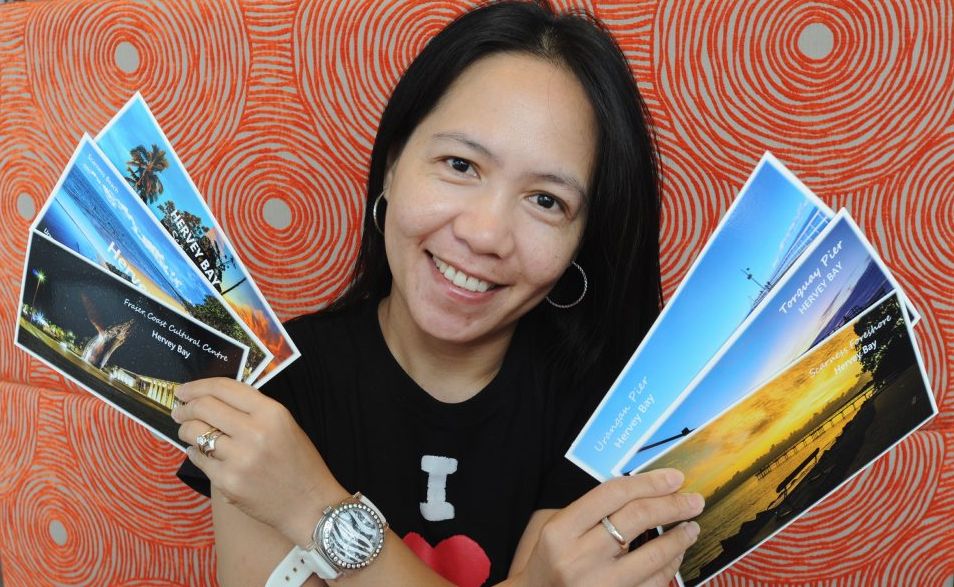 Photographer Ellen Foulds with her postcards of Hervey Bay. Photographer Ellen Foulds with her postcards of Hervey Bay.