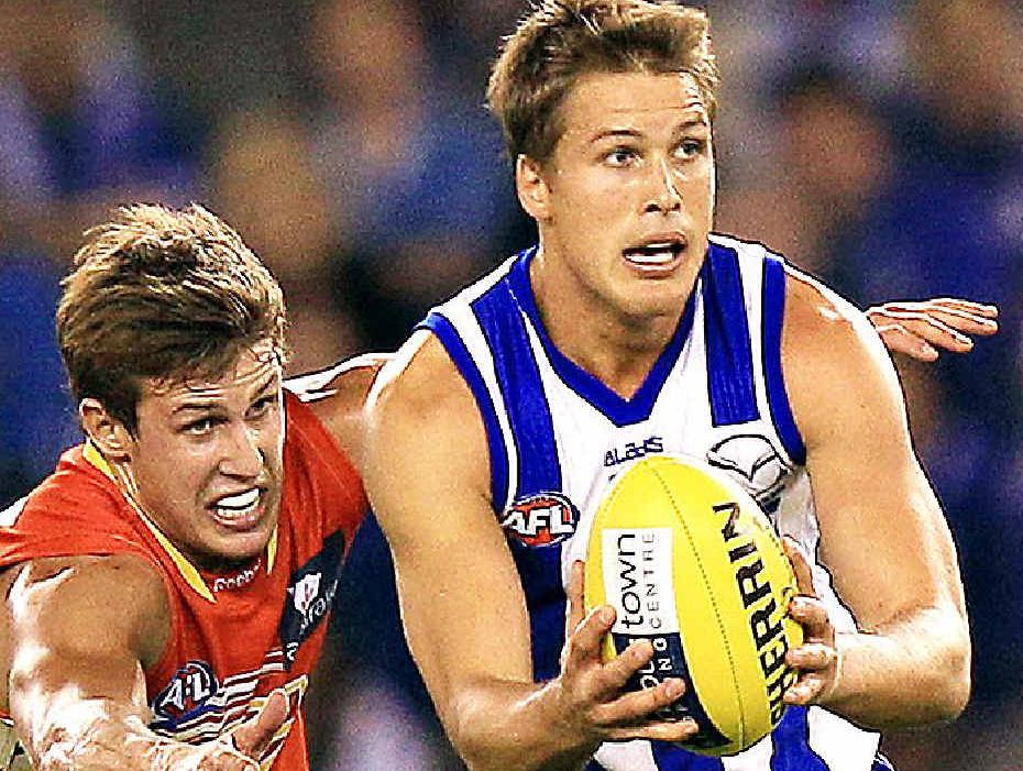 FOLLOWING IN HIS FOOTSTEPS: North’s Andrew Swallow runs off brother David, of the Gold Coast, during their teams’ clash at Etihad Stadium last year. FOLLOWING IN HIS FOOTSTEPS: North’s Andrew Swallow runs off brother David, of the Gold Coast, during their teams’ clash at Etihad Stadium last year.