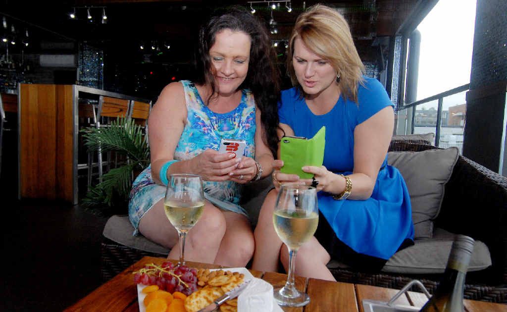 Tracy Coster and Chantelle Fielding at Mojos trying out new app. Tracy Coster and Chantelle Fielding at Mojos trying out new app.