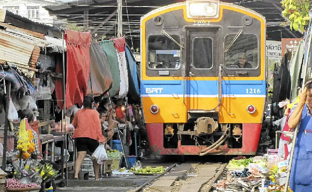 The train passes over low-lying trays as it passes through the market. The train passes over low-lying trays as it passes through the market.
