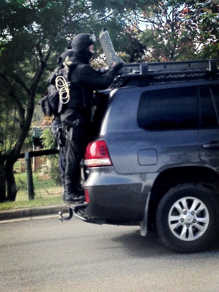 Heavily armed Special Emergency Response Team members at the Redbank Plains siege on Saturday morning. Image: Channel 9 Heavily armed Special Emergency Response Team members at the Redbank Plains siege on Saturday morning. Image: Channel 9