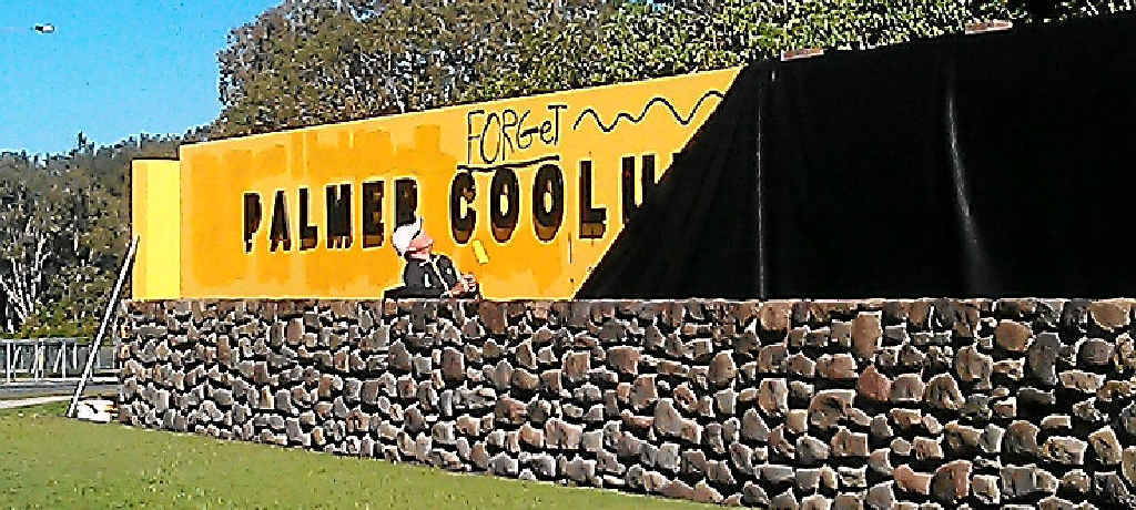 COVER UP: A painter blots out the graffiti on the front sign of the Palmer Coolum Resort. COVER UP: A painter blots out the graffiti on the front sign of the Palmer Coolum Resort.