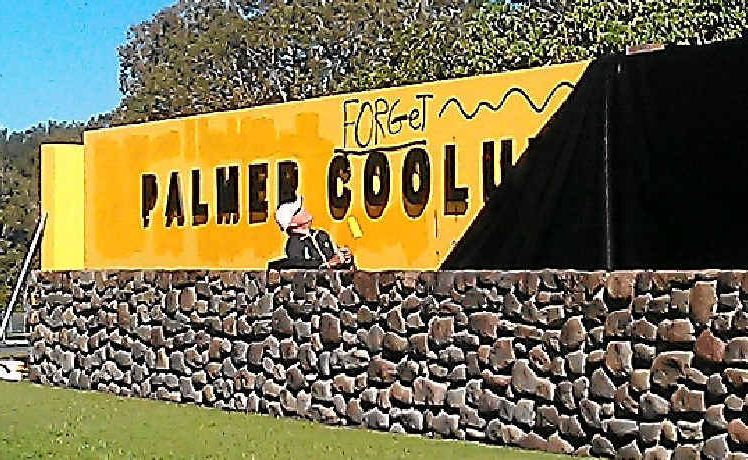 COVER UP: A painter blots out the graffiti on the front sign of the Palmer Coolum Resort. COVER UP: A painter blots out the graffiti on the front sign of the Palmer Coolum Resort.