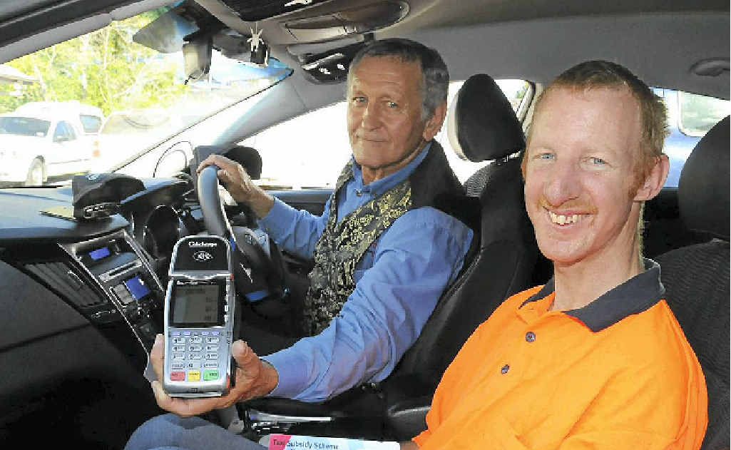 Taxi driver Ian Sims with regular passenger of the Taxi Subsidy Scheme Craig Sinn. Taxi driver Ian Sims with regular passenger of the Taxi Subsidy Scheme Craig Sinn.